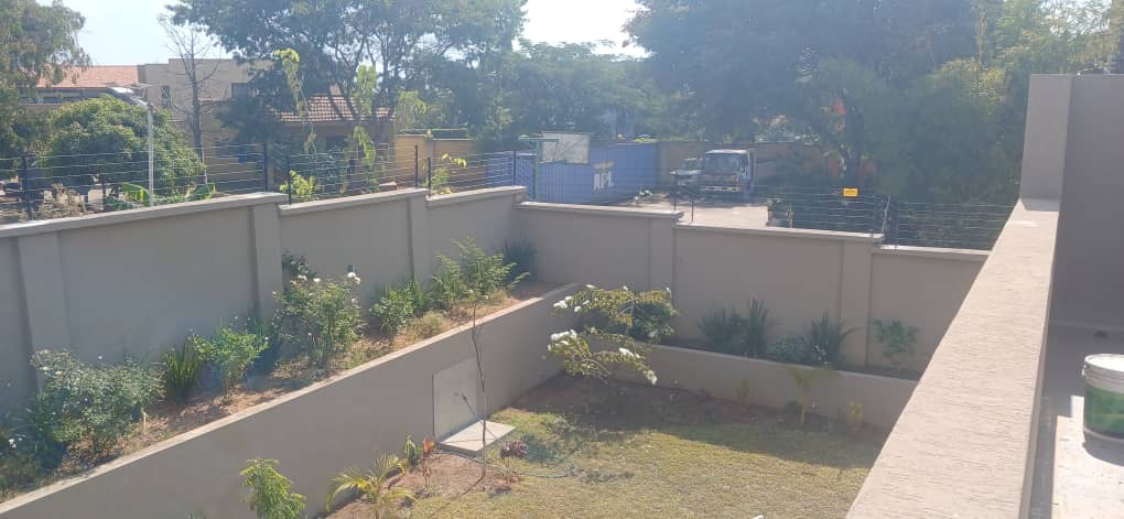 Completed electric fence installation along a boundary wall
